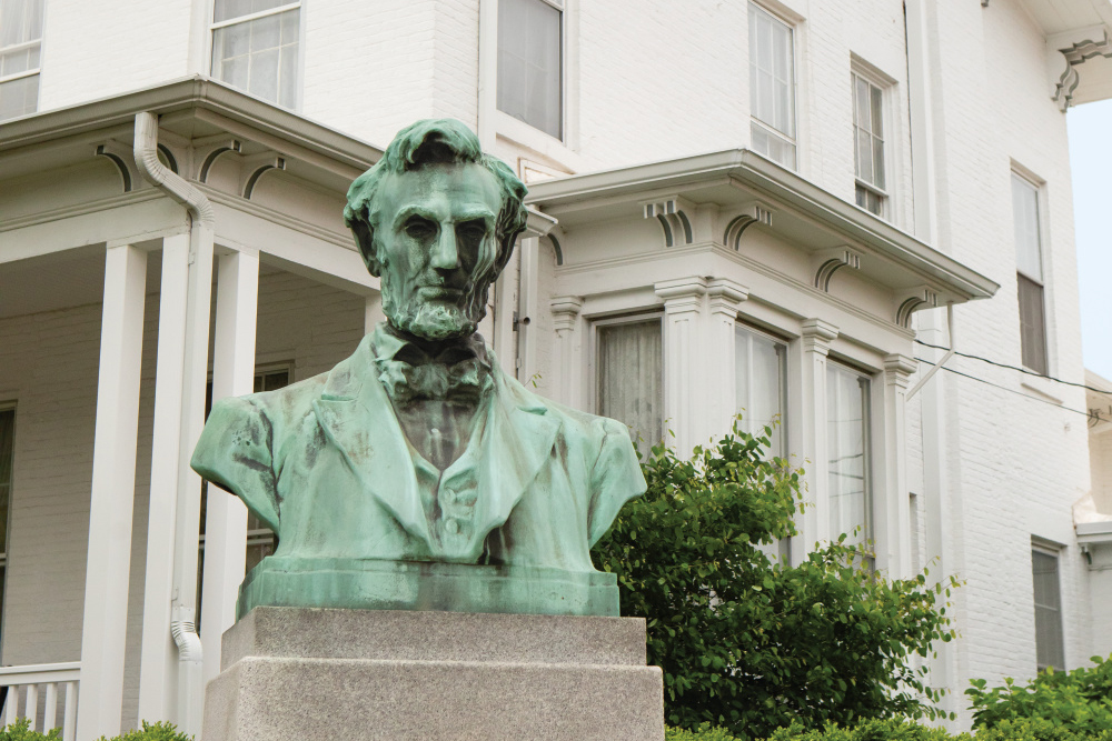 A bust of Abraham Lincoln in front of the Geneseo Historical Museum