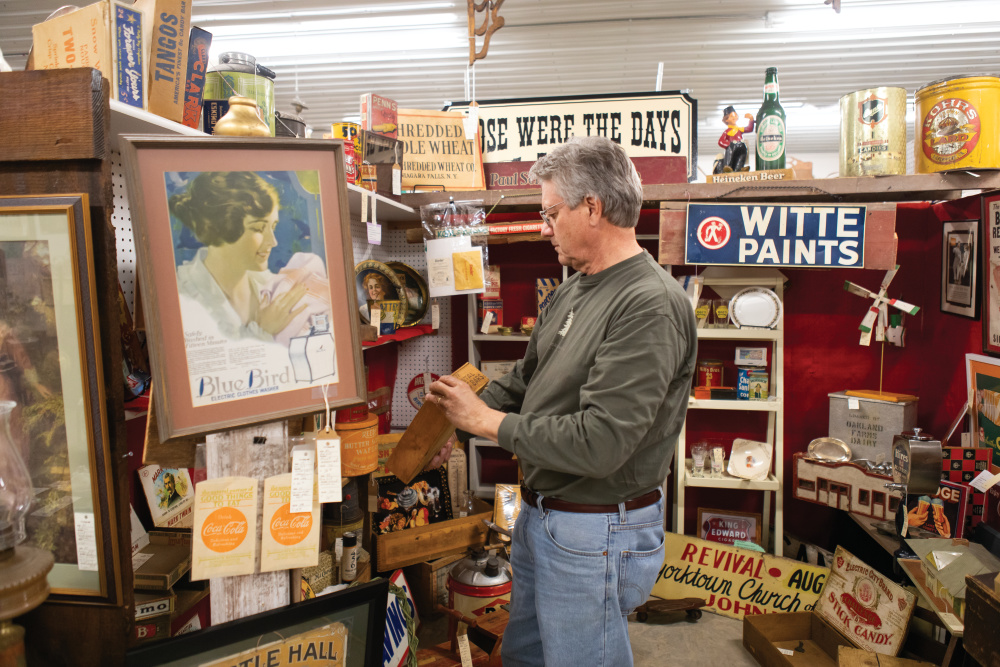 Man browsing displays at C&S Antiques in Geneseo