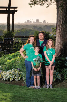 Erica and Brian Kniffin with their kids, Andrew and Emma, at their Hostas on the Bluff farm with the St. Louis skyline in the background