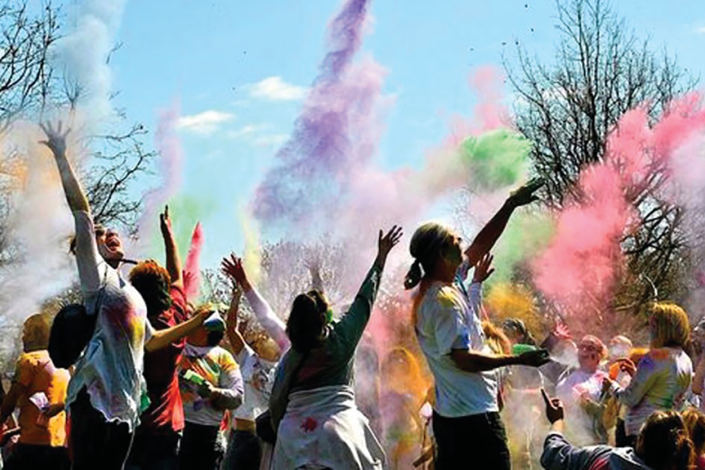 People tossing colors into the air at Holi – The Festival of Colors