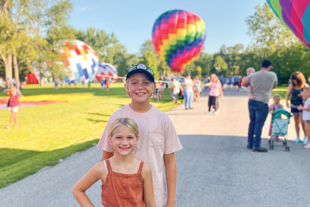 Two kids pose for a photo at Centralia Balloon Fest, one of the things to do in Clinton County