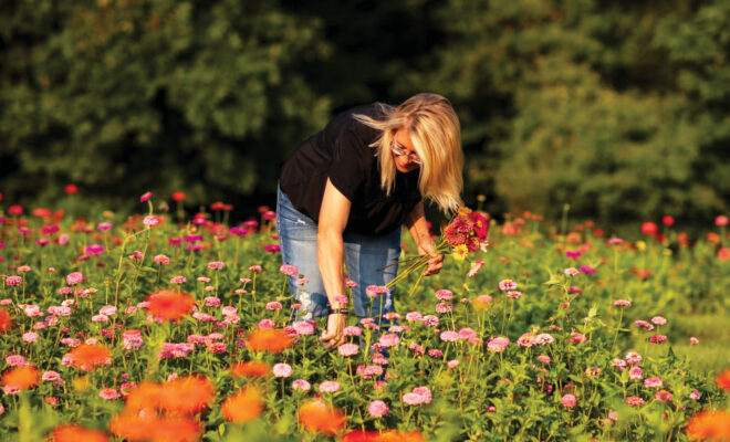 Woman picking flowers in a field at Wild Child Flower Farm