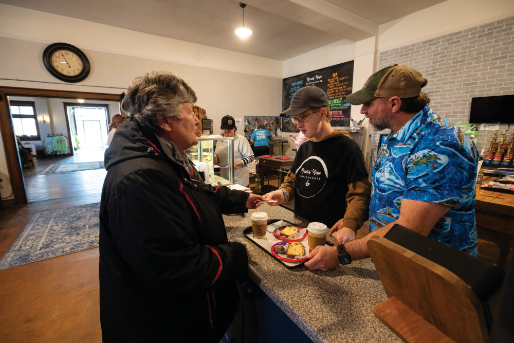 Luke Wemple and volunteer job coach Rob Snyder filling orders at Brewin' Hope Coffeehouse