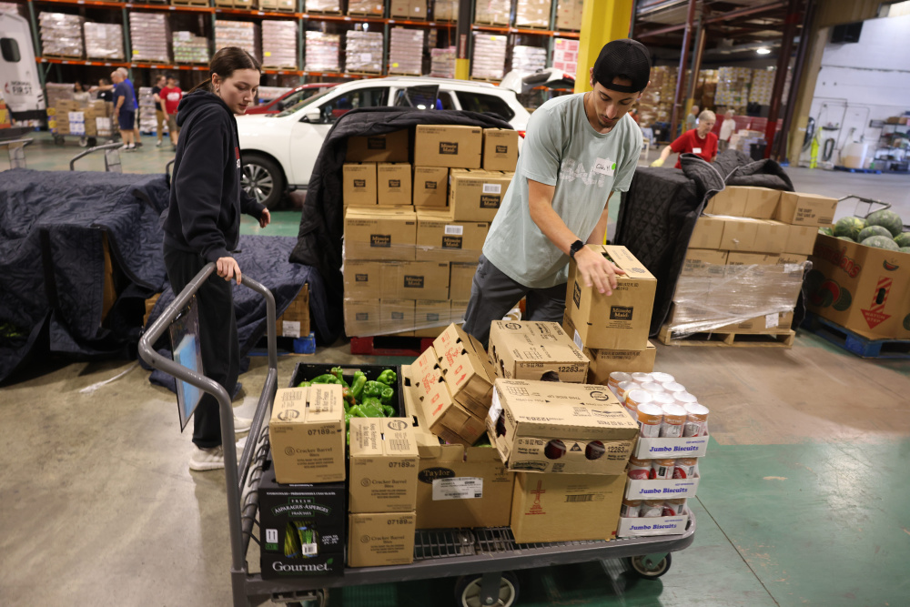 Volunteers load vans with food at Midwest Food Bank in Normal, Illinois. 