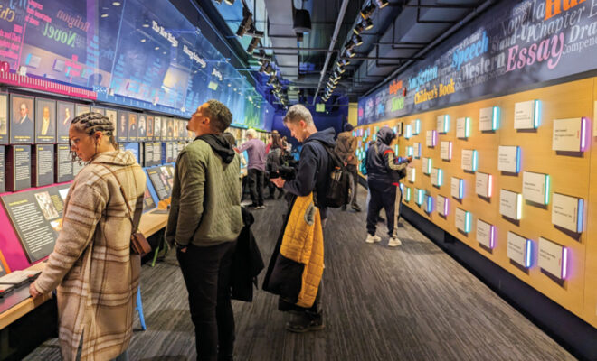 People looking at one of the exhibits at the American Writers Museum
