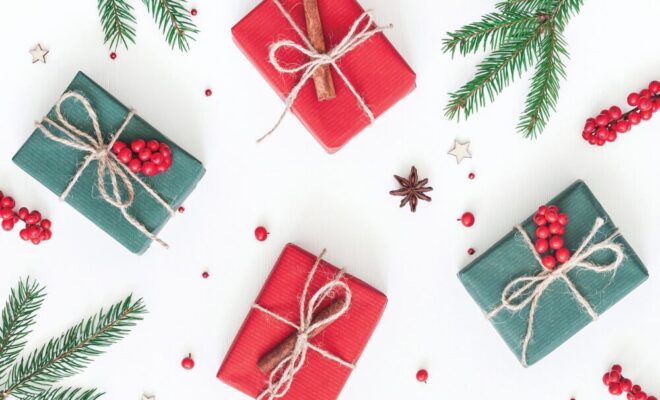 Wrapped gifts with greenery and berries around them