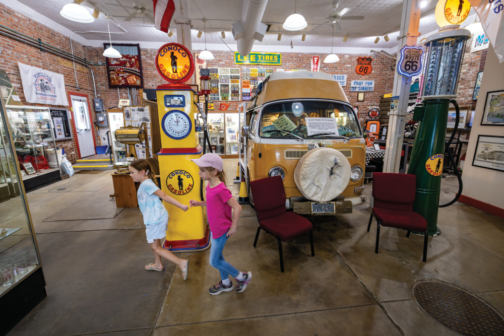 Two kids exploring exhibits at the Route 66 Association Hall of Fame & Museum in Pontiac