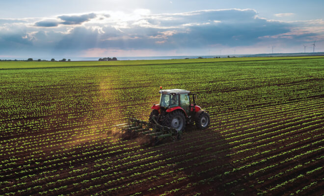 Tractor cultivating a field