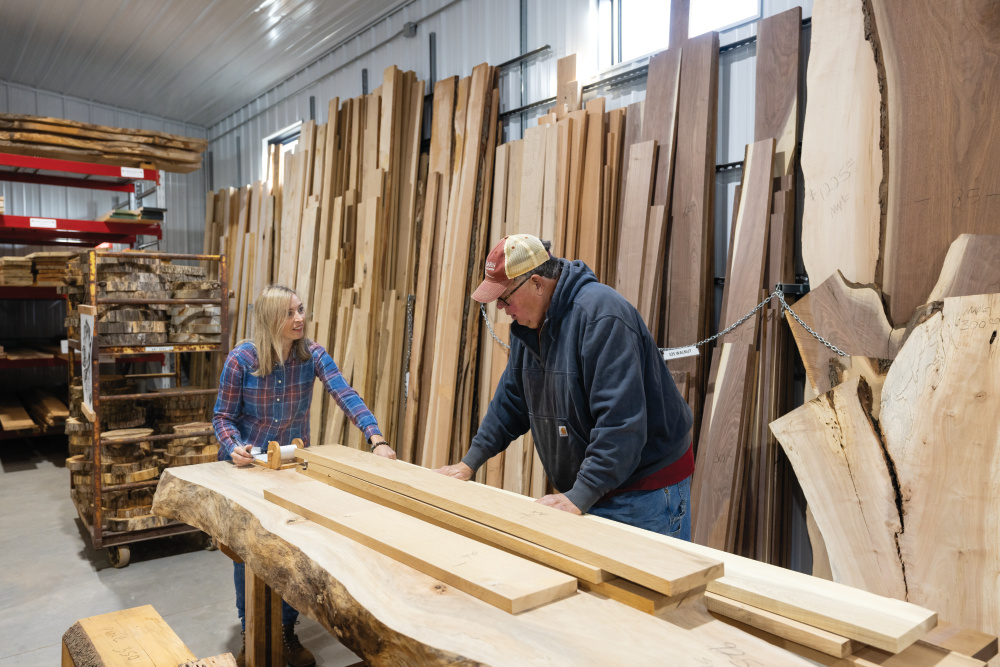 Angie DeVolder helps Ed Schneckloth choose hardwood boards at Stella Sawmill